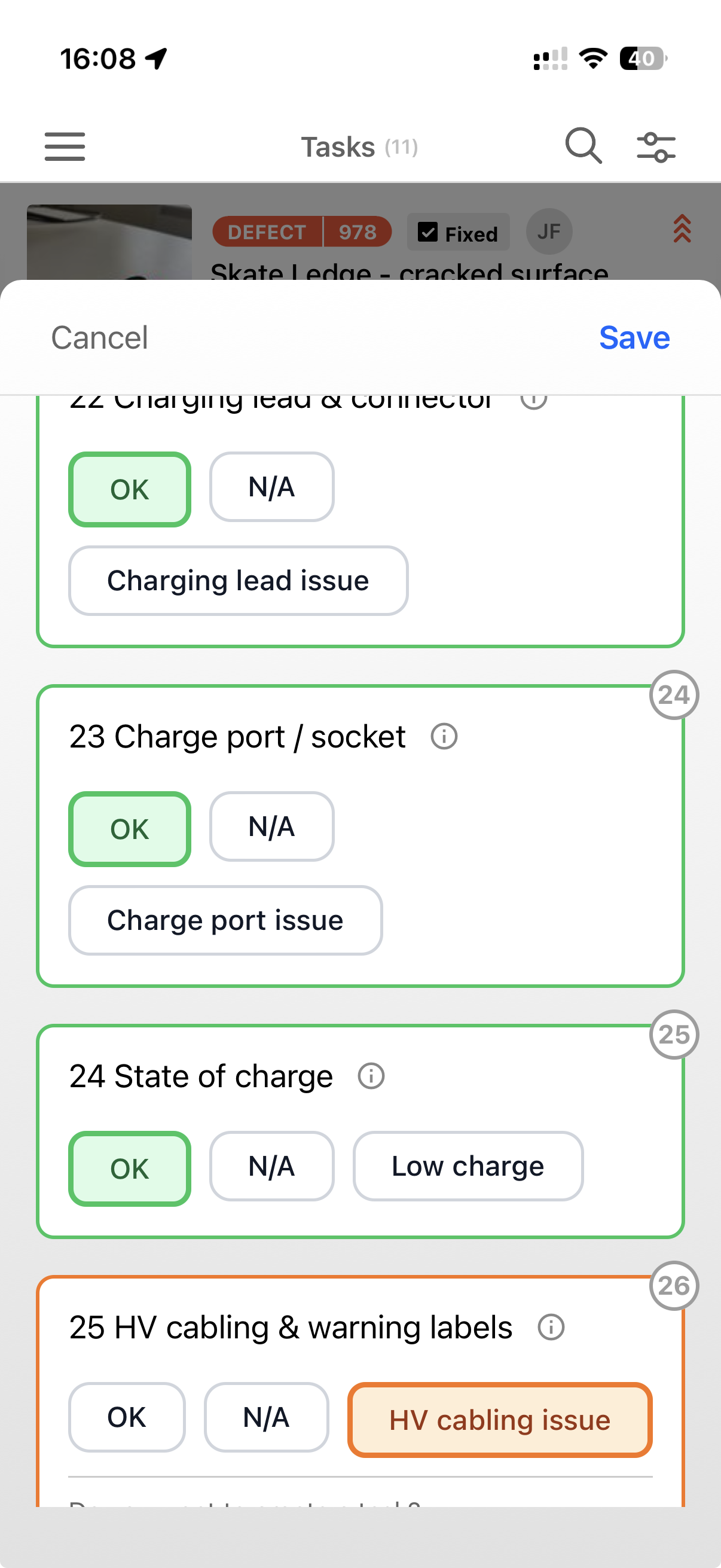 An electric vehicle checklist on mobile, with items for charging lead and connector, charge port or socket, state of charge, and HV cabling and warning labels, each with OK, N/A and fault responses